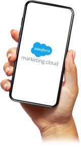 Hand holding a phone displaying the Salesforce Marketing Cloud logo.